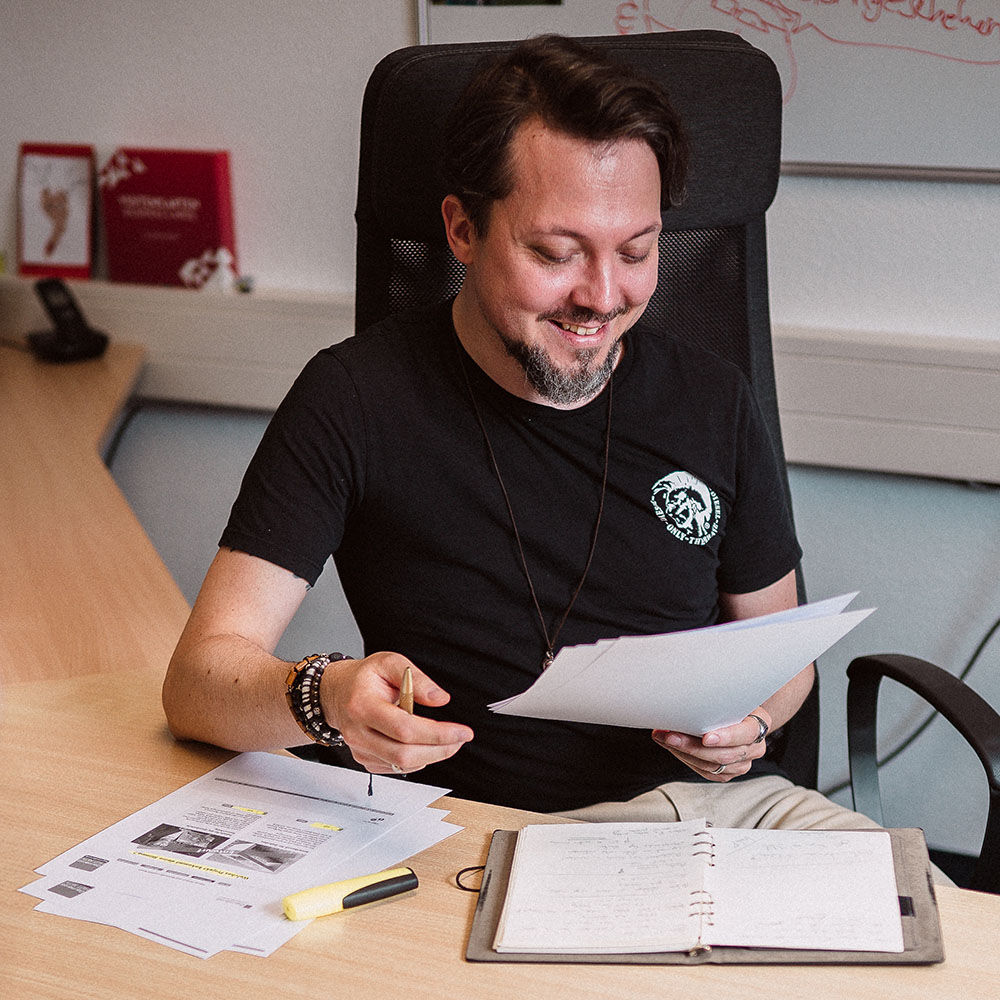 Projektmanager Paul von YTPI prüft Unterlagen in einem Meeting